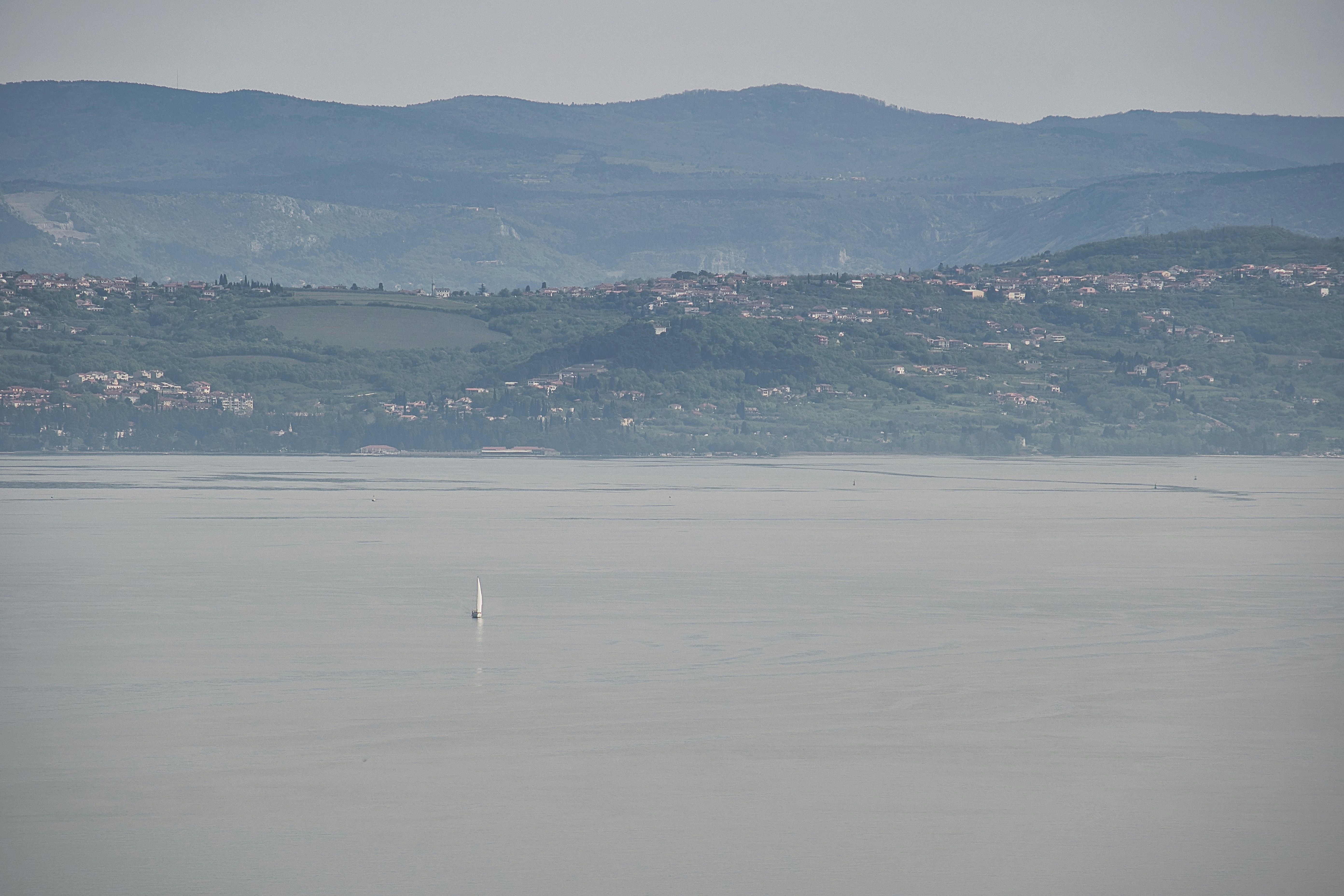 A view of a body of water with mountains in the background