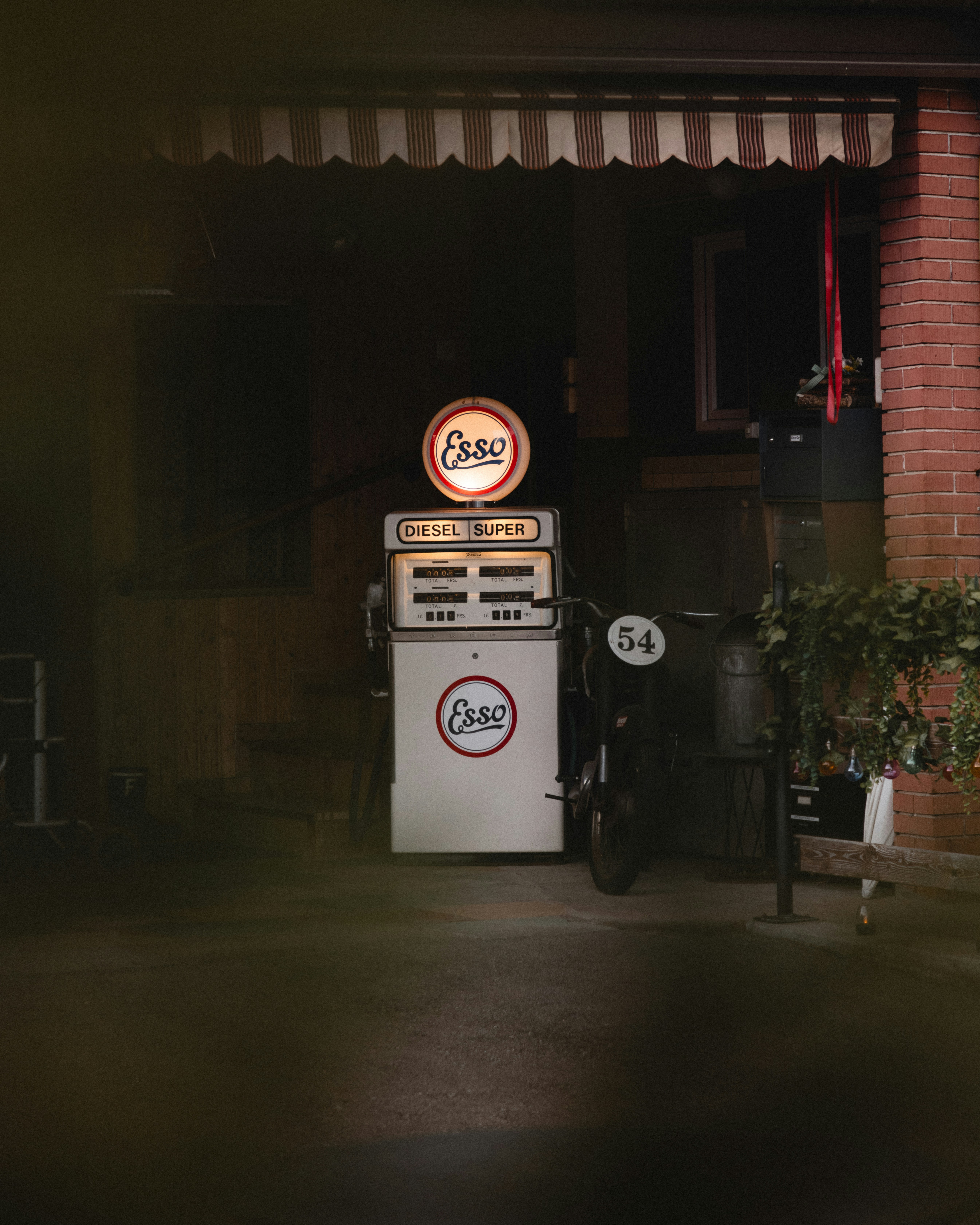 A gas pump sitting outside of a building