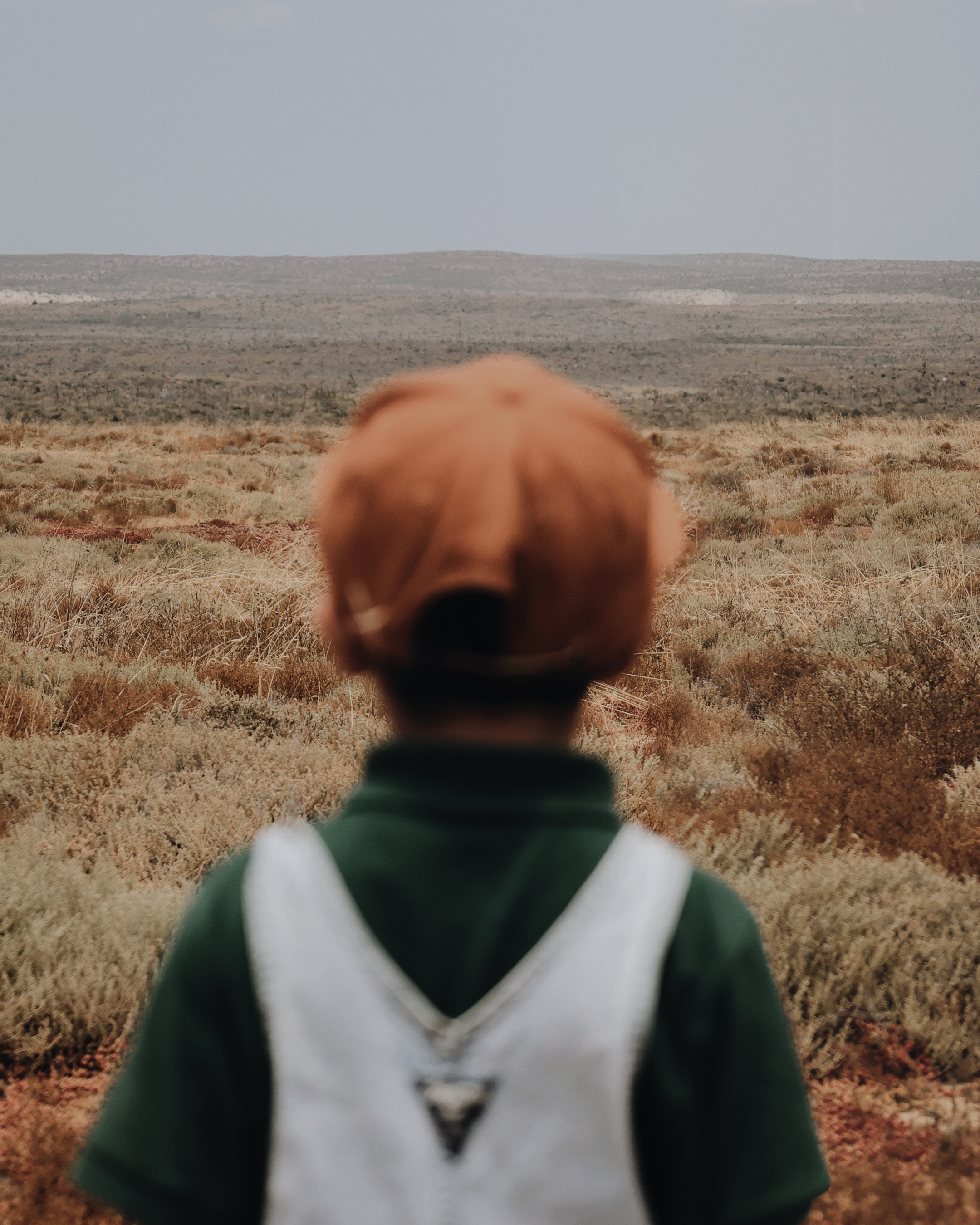 A person with a red hair standing in a field
