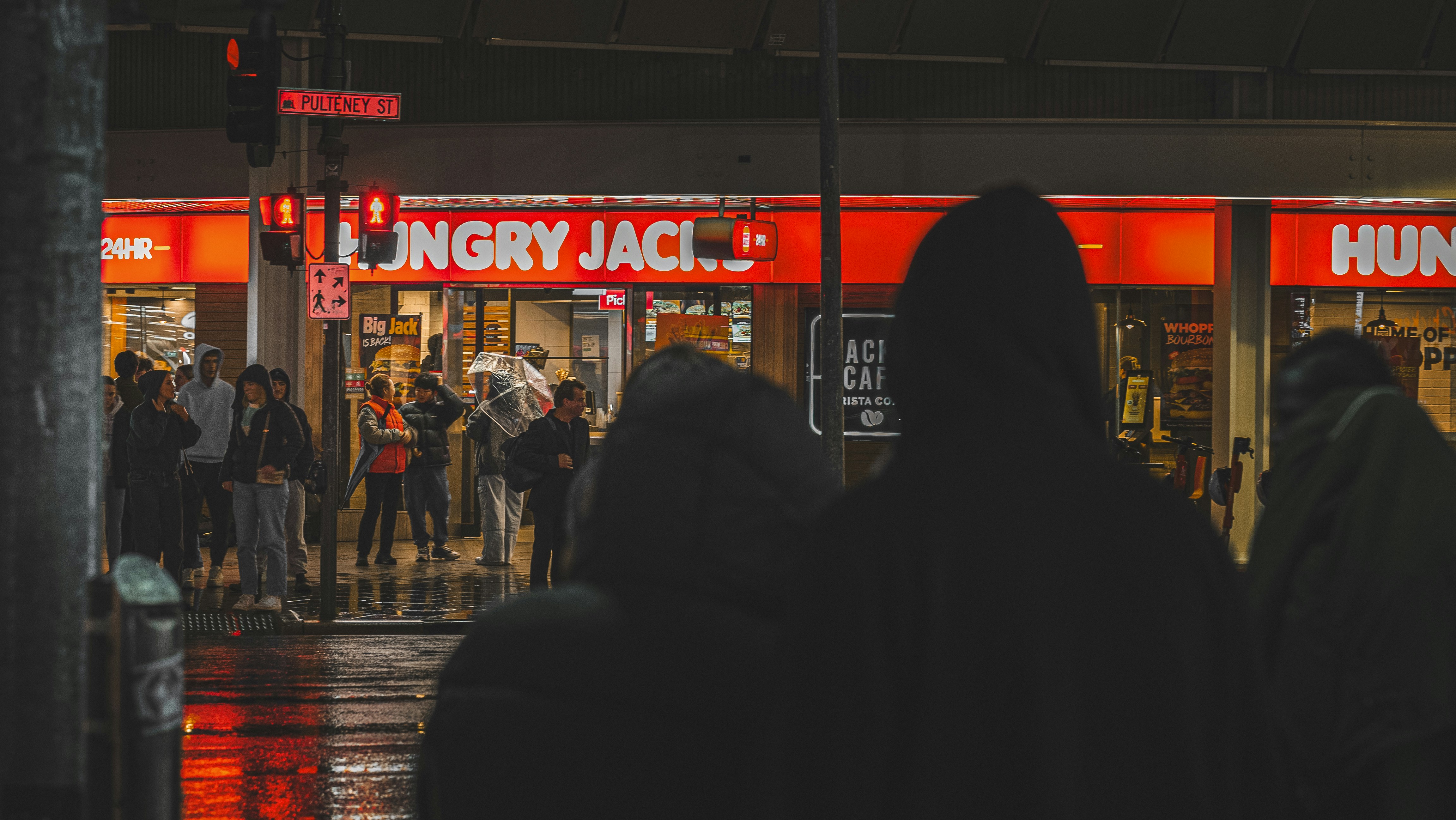 A group of people standing in front of a store