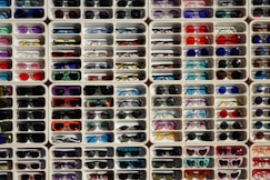 A large display of sunglasses and sunglasses for sale