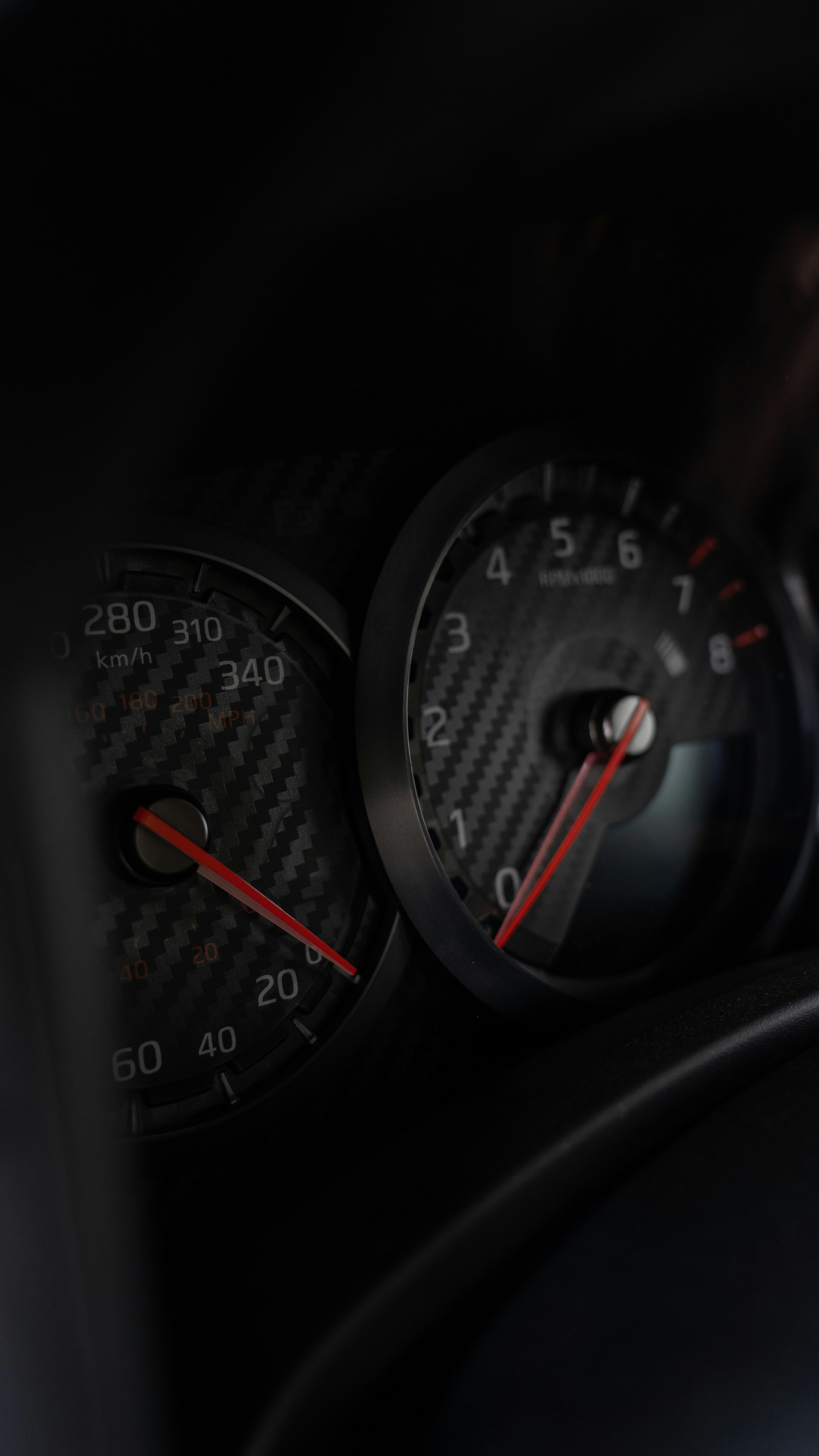 A close up of a car dashboard with a speedometer