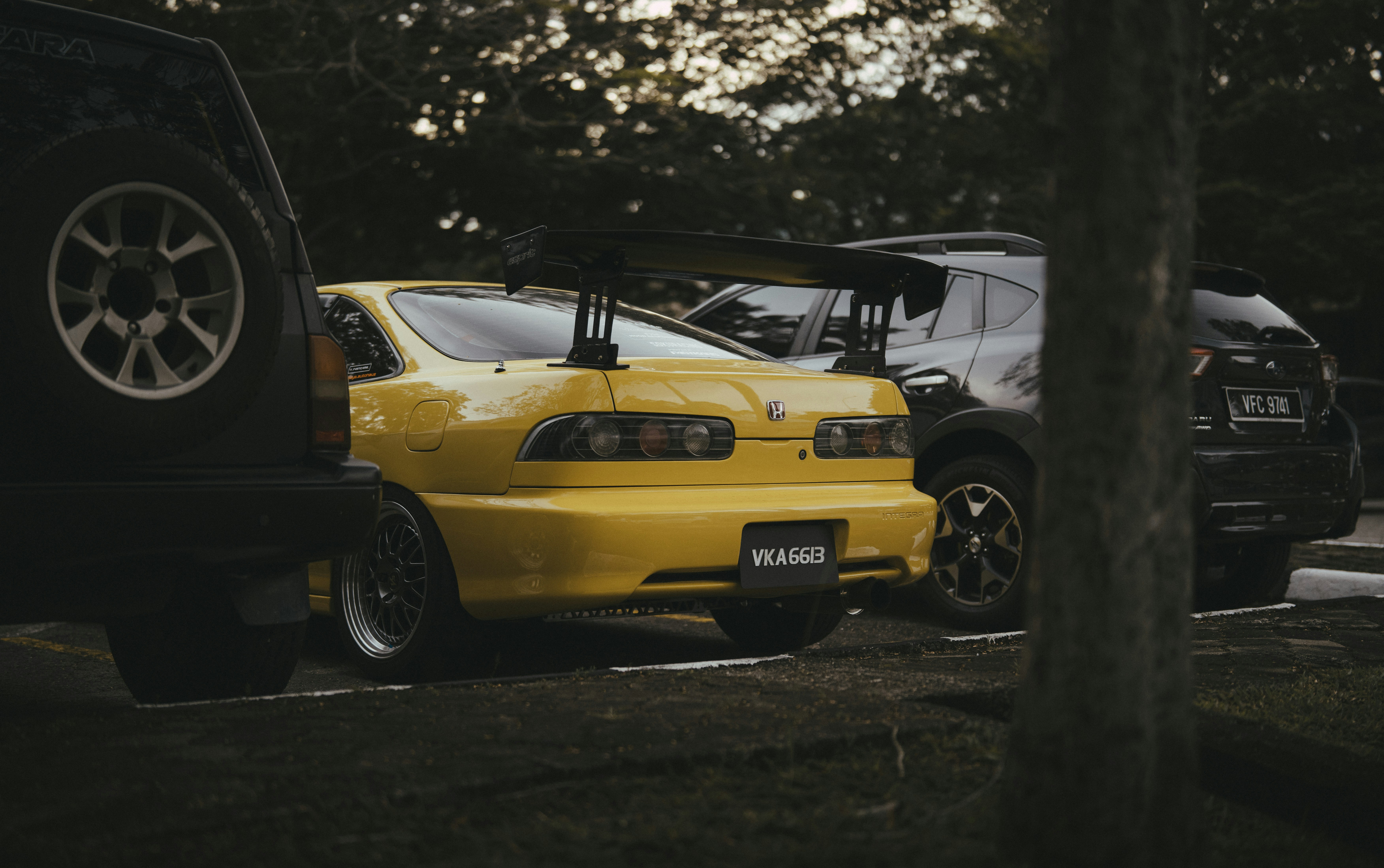 A group of cars parked next to each other in a parking lot