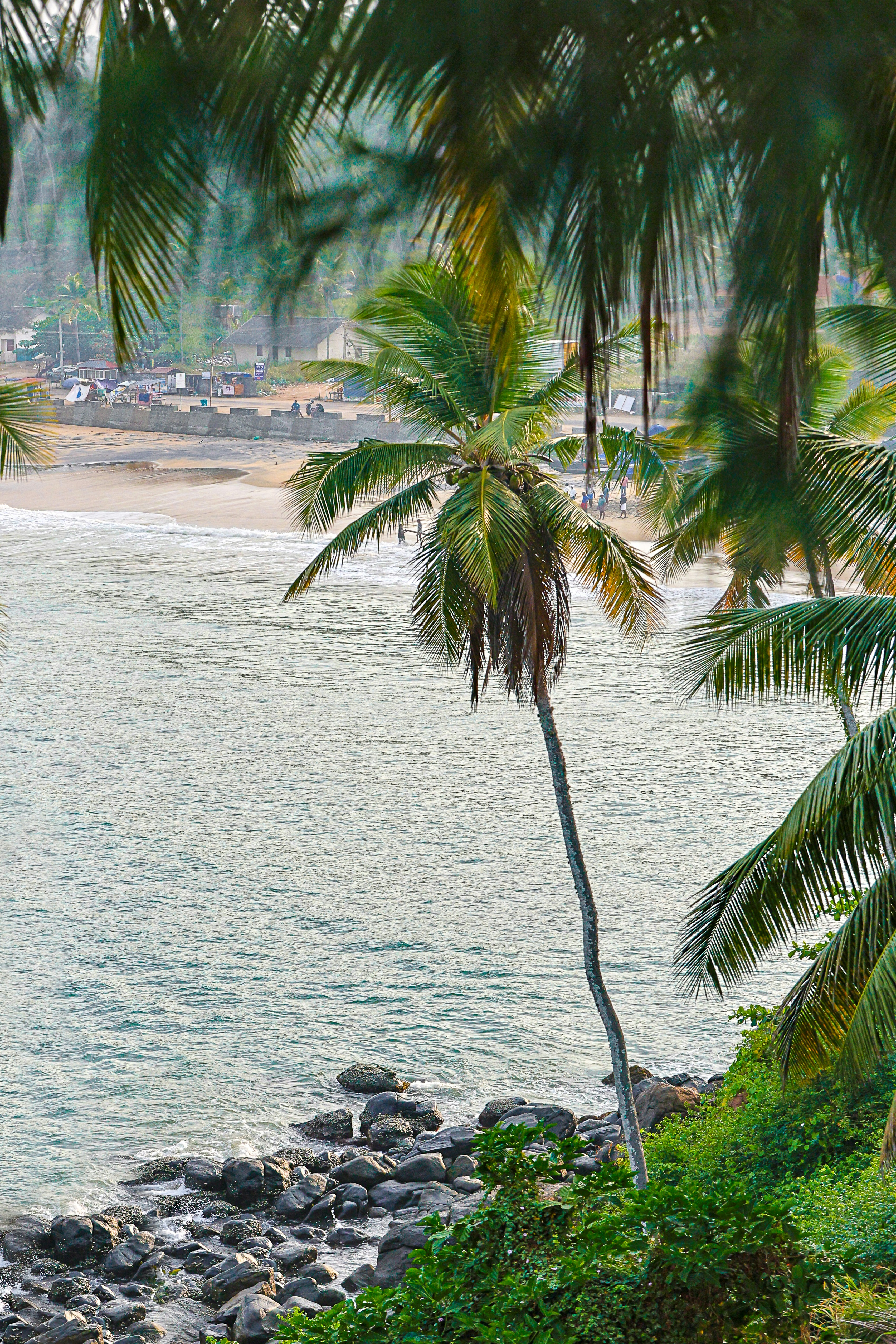 A man riding a surfboard on top of a sandy beach