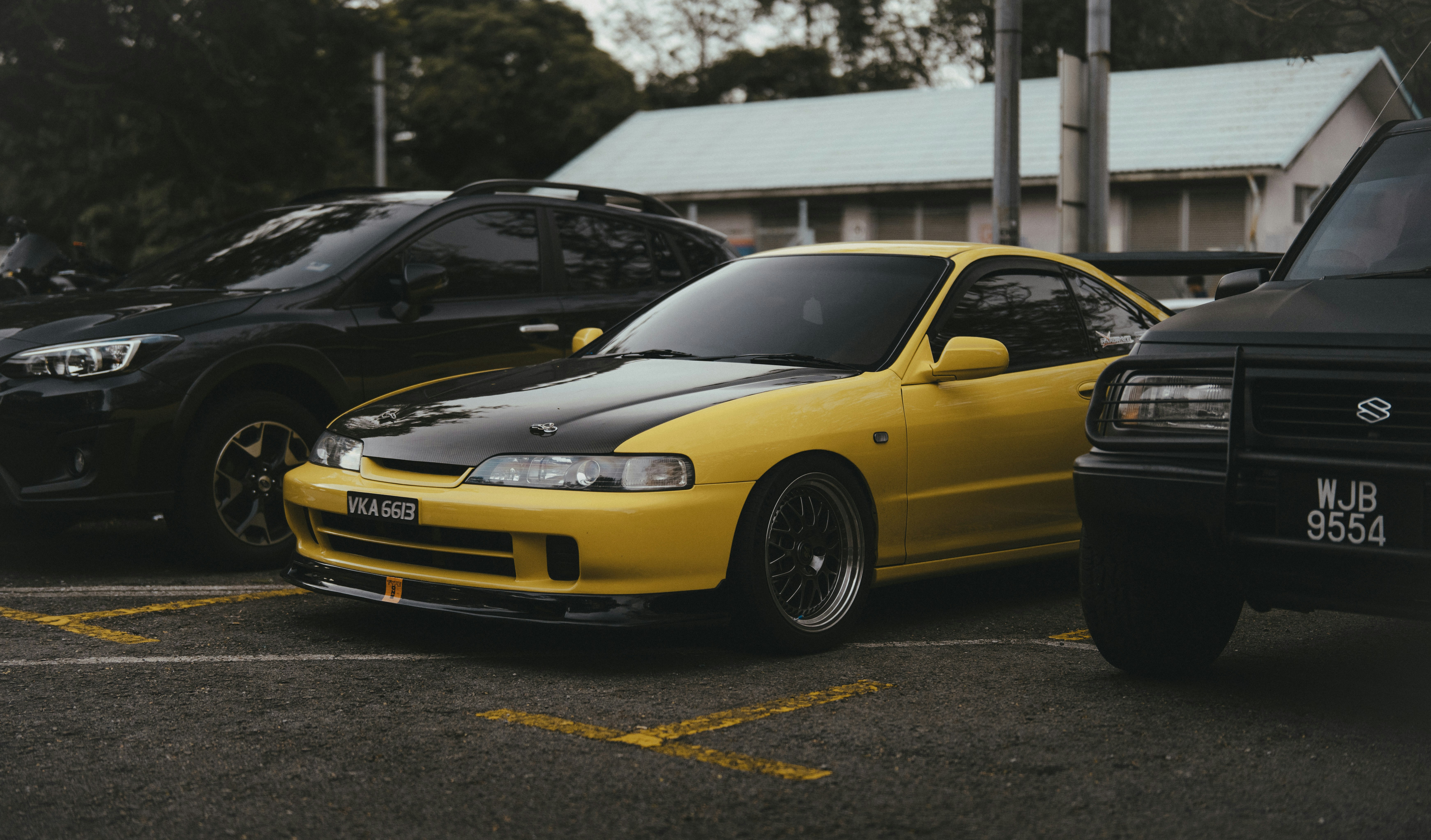 A group of cars parked next to each other in a parking lot