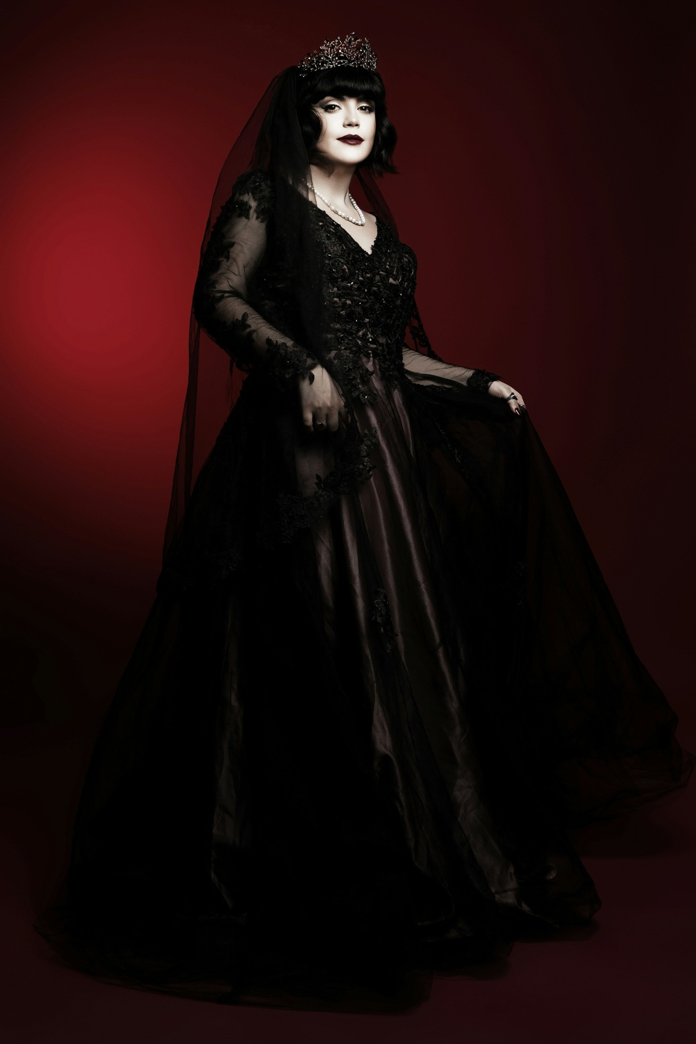 A woman in a black dress and a tiara