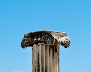 A close up of a column with a sky in the background