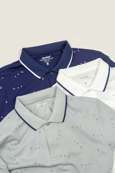Three men's polo shirts sitting next to each other