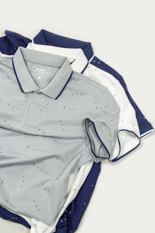 Three polo shirts laying on top of each other