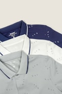 Three men's polo shirts on a white background
