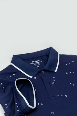 A blue polo shirt with white writing on it