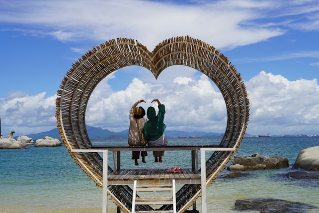 A couple of birds sitting on top of a wooden bench