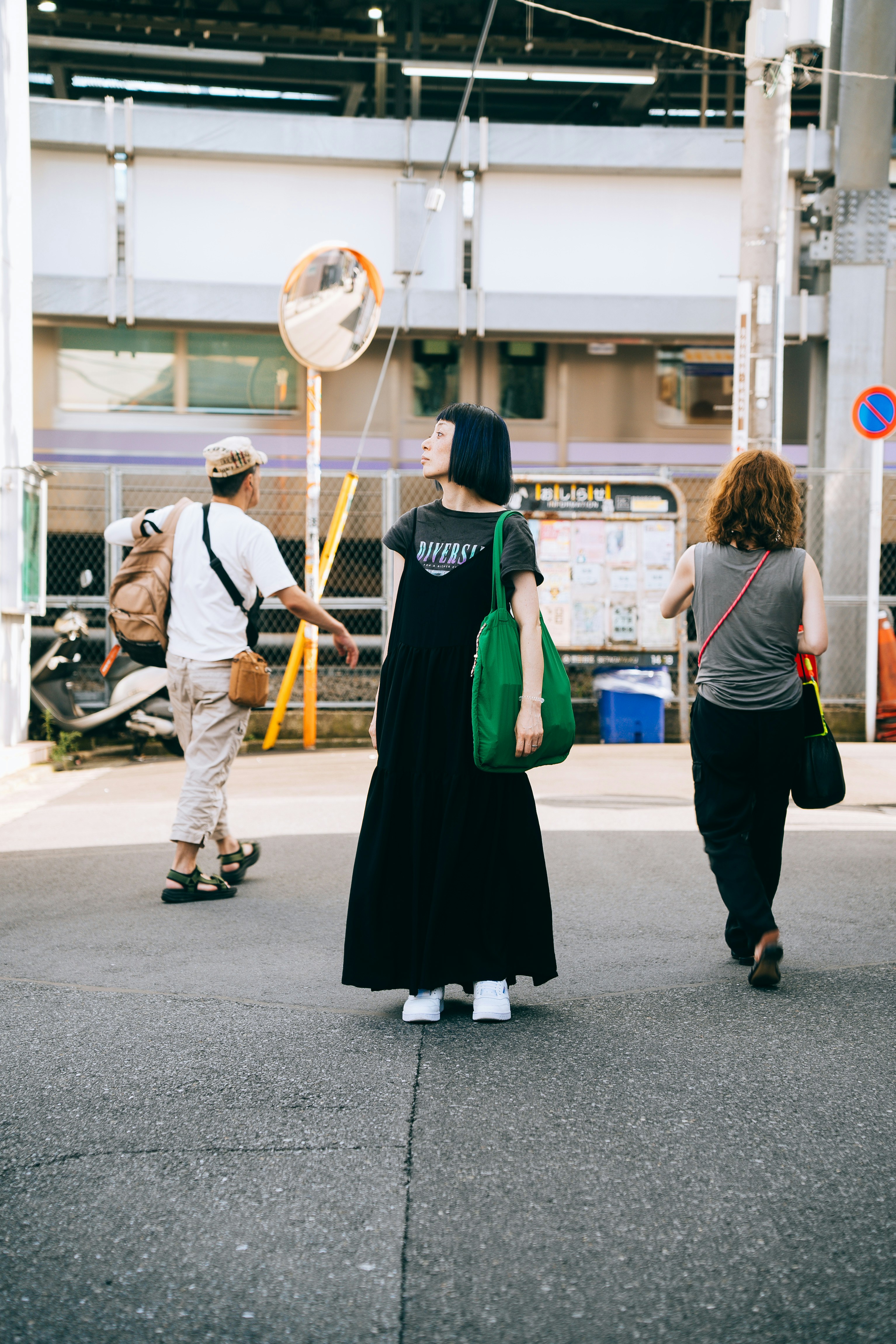 A group of people walking down a street