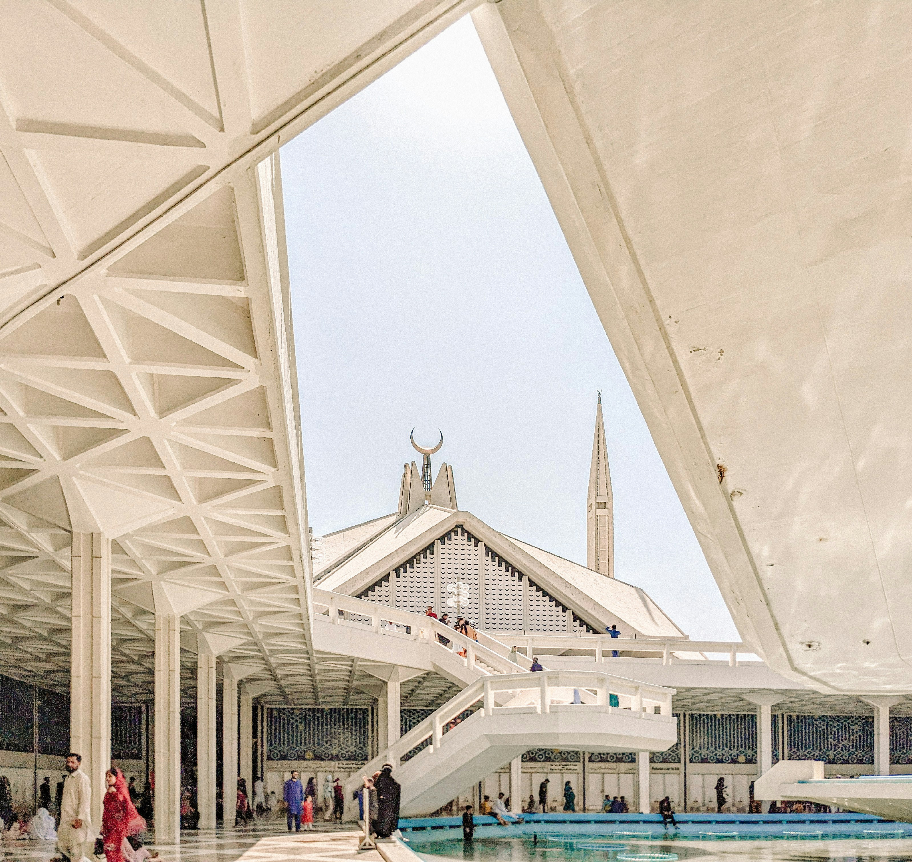A group of people walking around a building