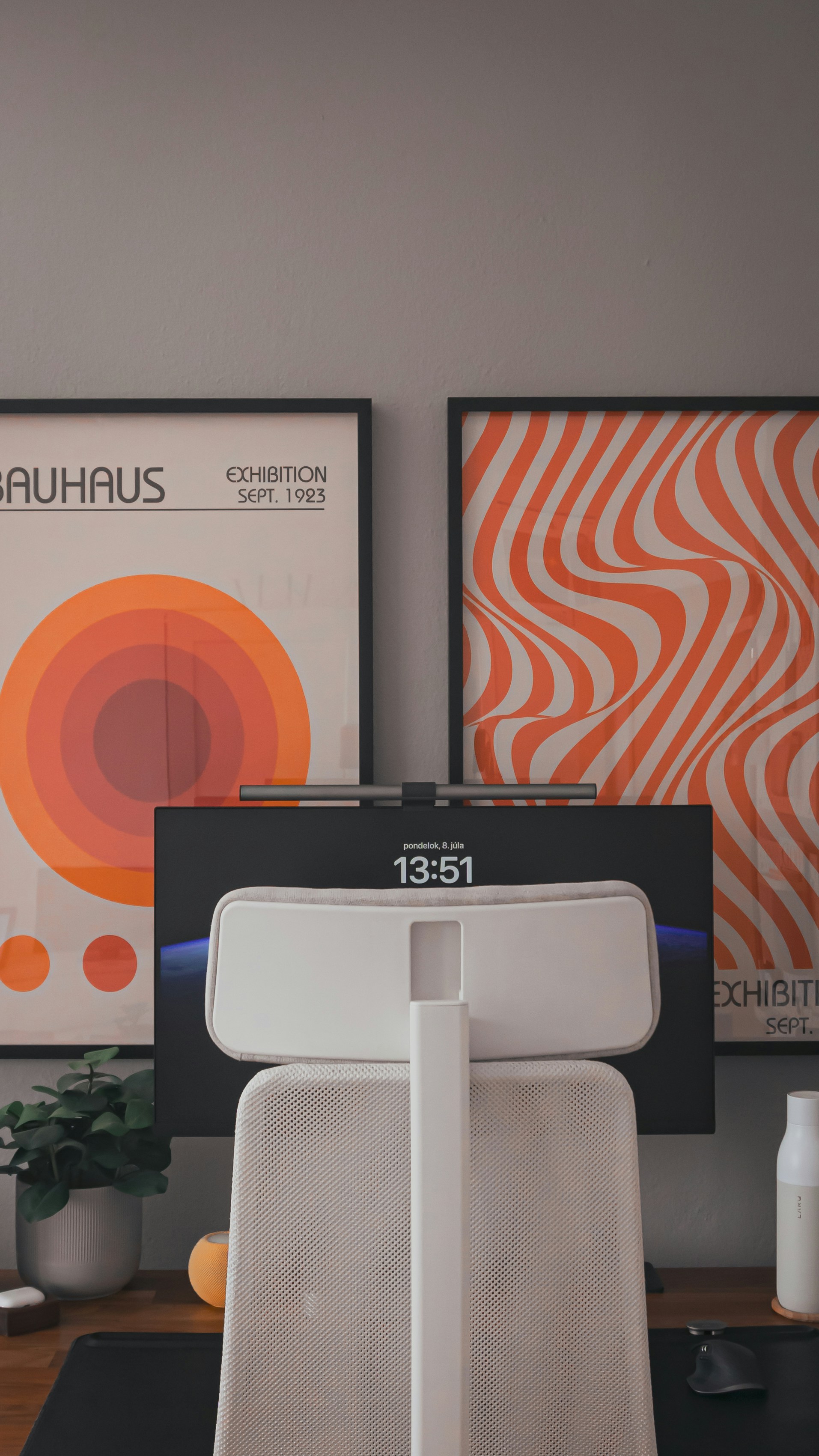 A desk with a computer monitor and a printer on it