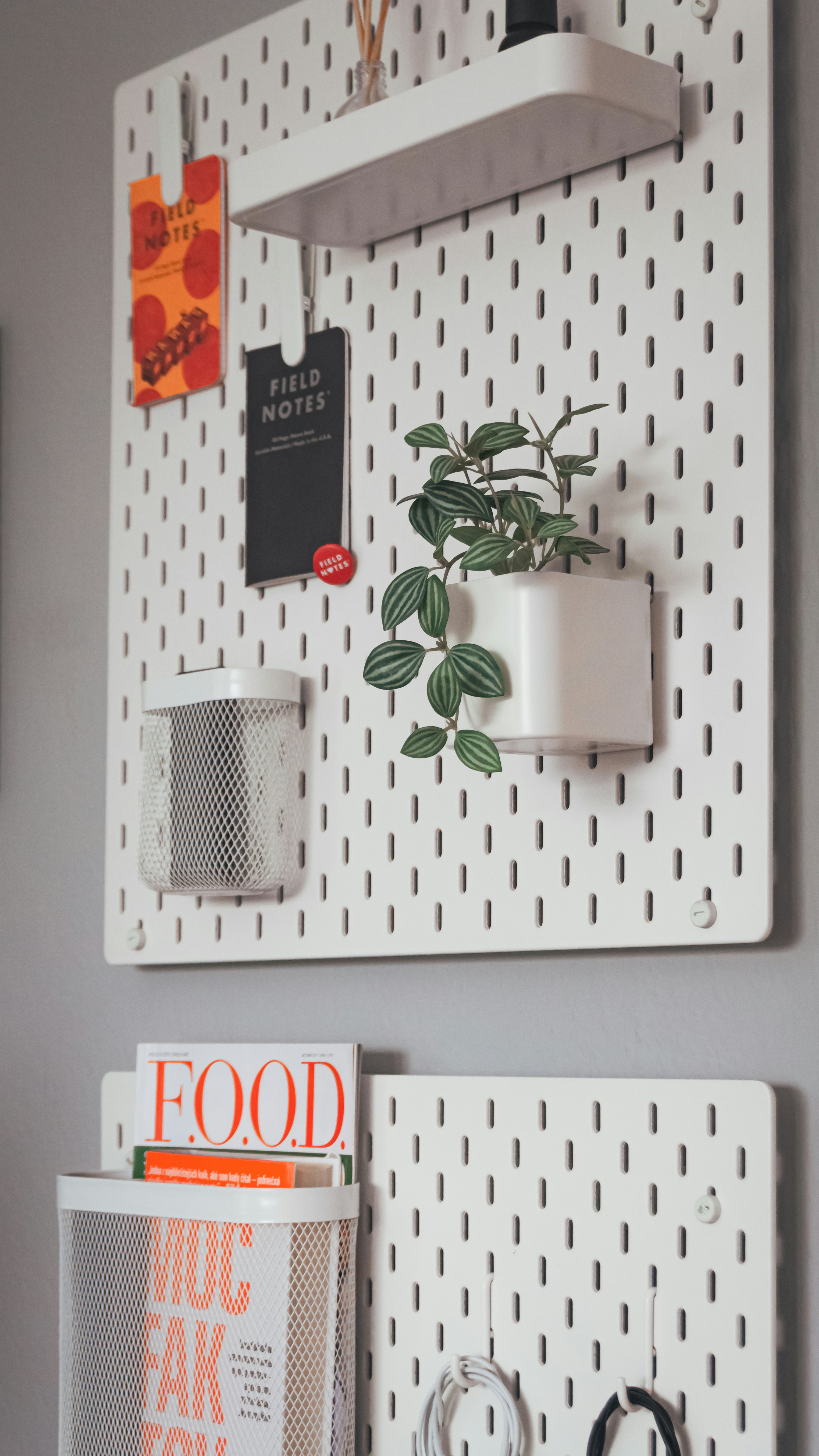 A couple of white pegboards mounted to the side of a wall
