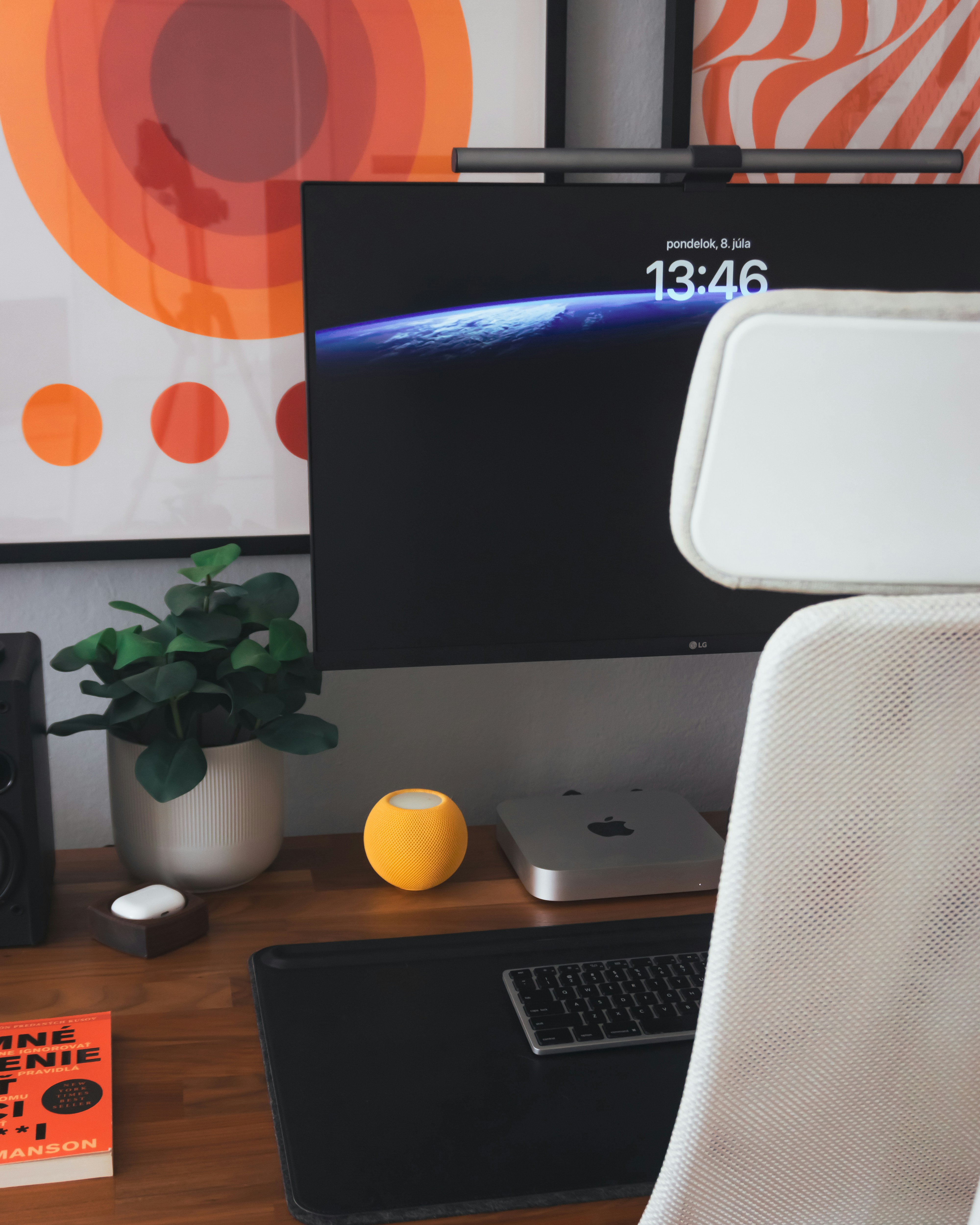 A white chair sitting in front of a computer desk
