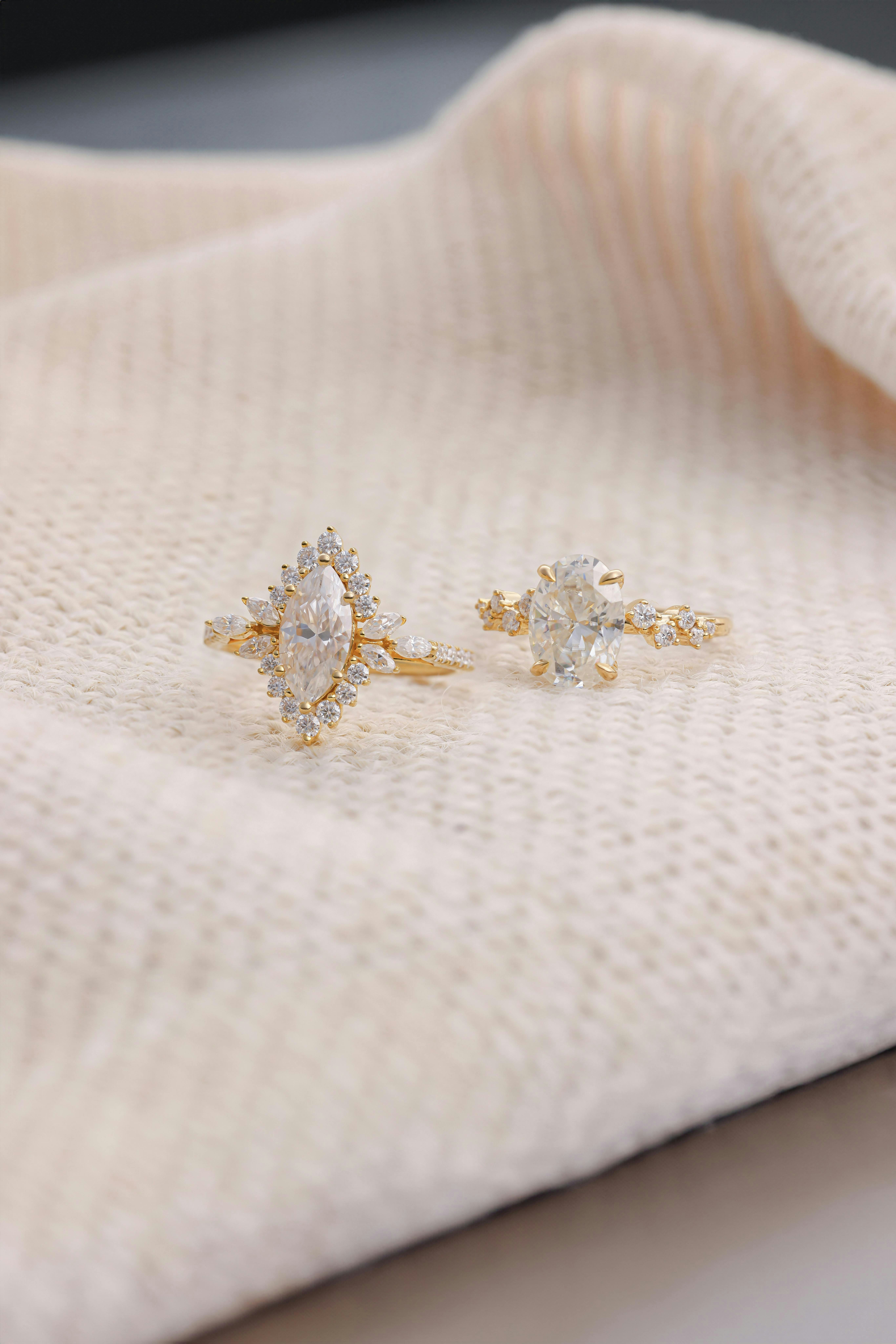 A pair of earrings sitting on top of a white cloth