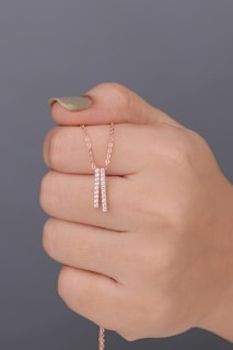 A woman's hand holding a diamond bracelet