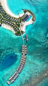 An aerial view of a resort in the middle of the ocean