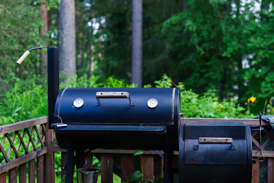 A bbq grill sitting on top of a wooden deck