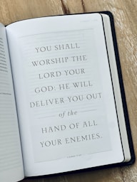 An open bible on a wooden table