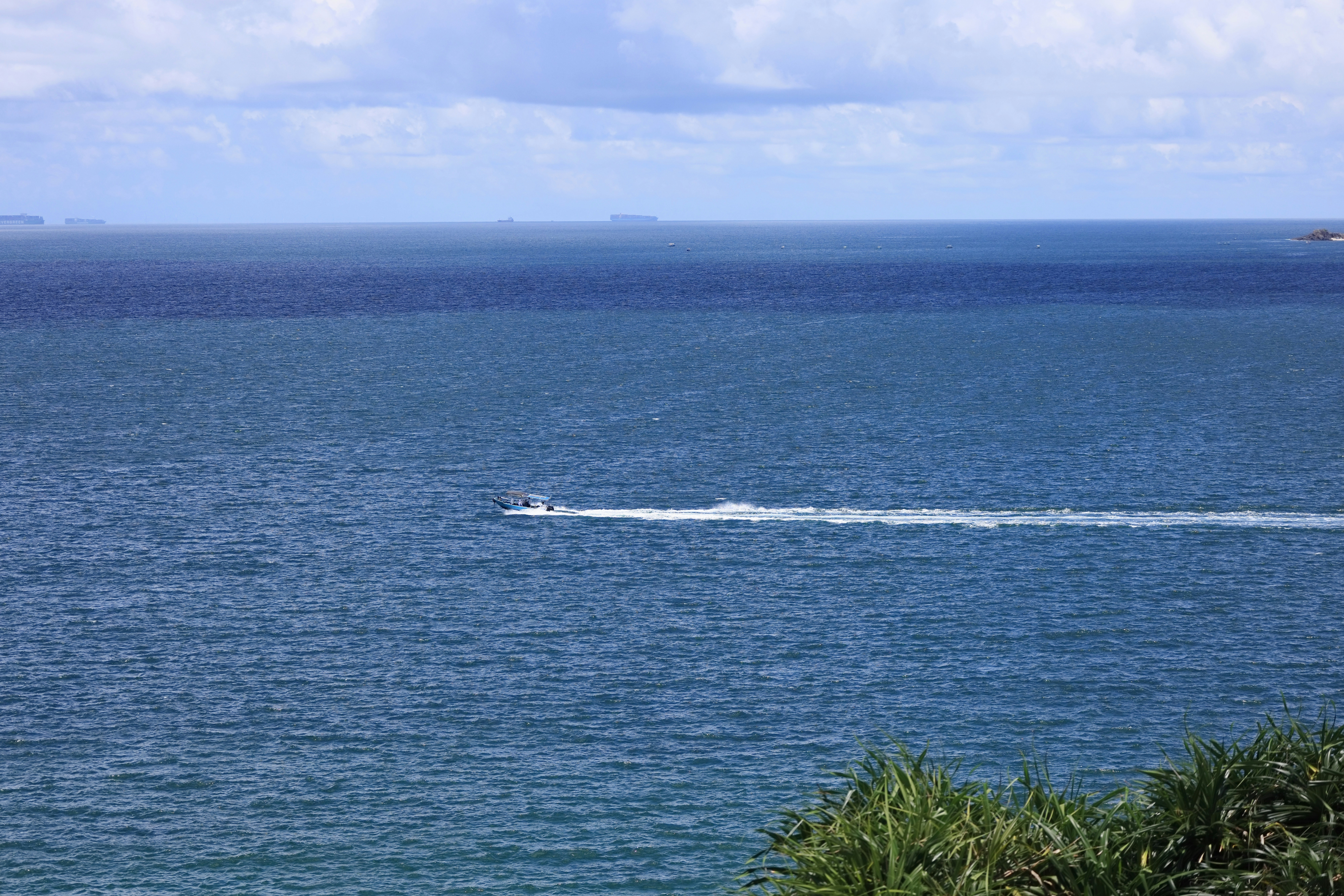 A majestic catamaran sailing in the clear waters of Maui
