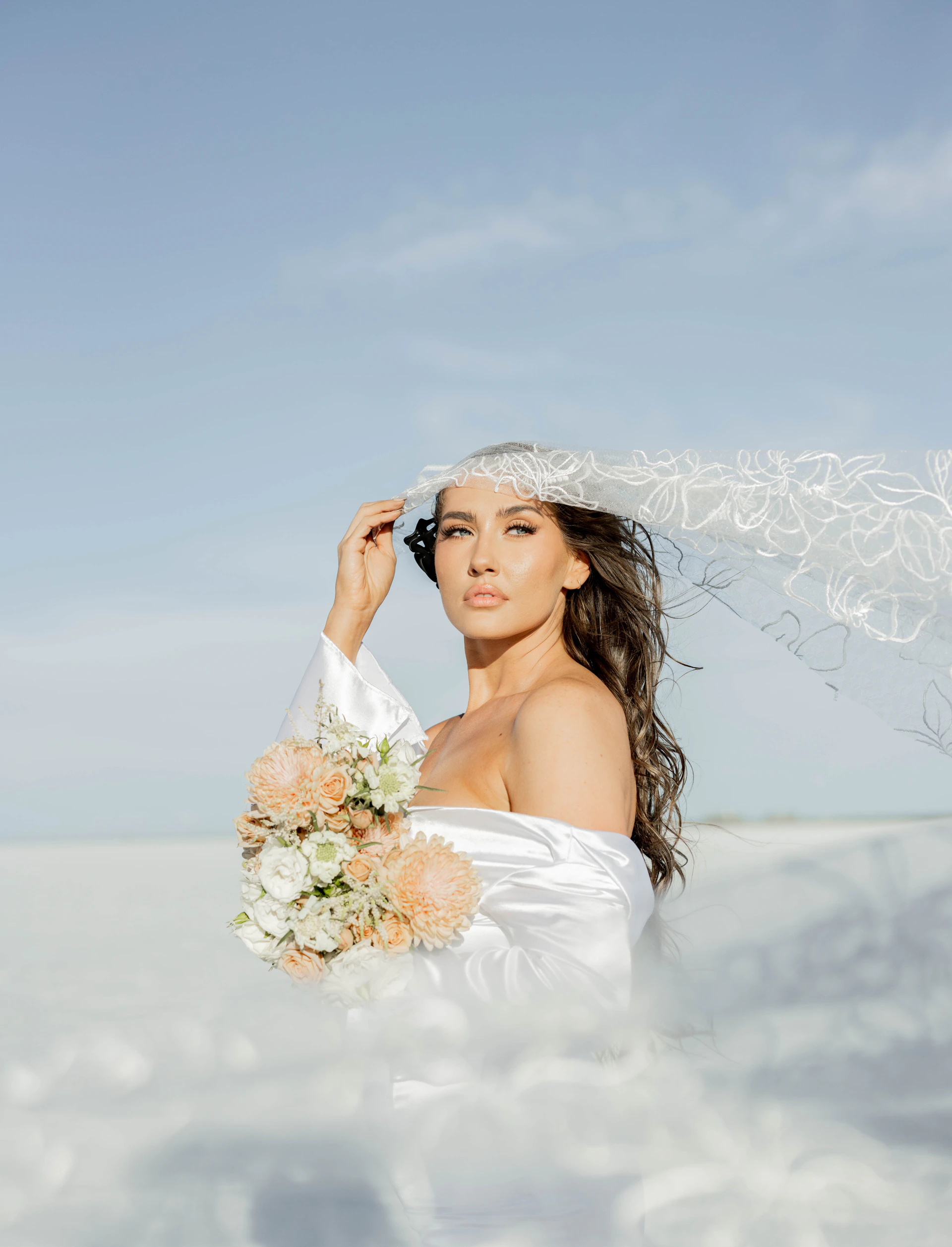 A woman in a wedding dress holding a bouquet of flowers