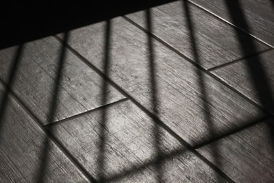 The floor is made of wood and has bars on it