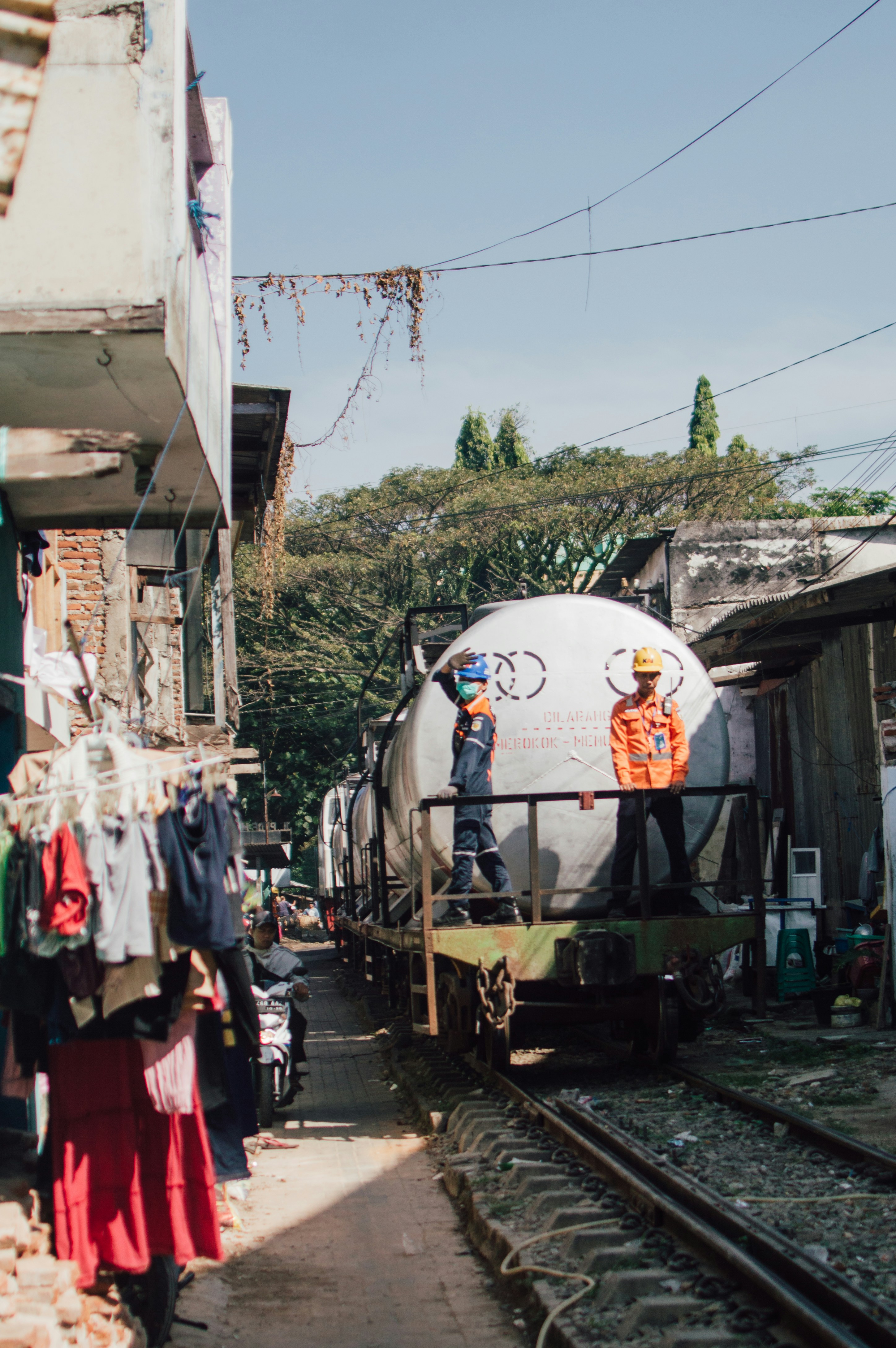 A group of people standing next to a train track