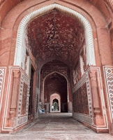 A hallway in a building with intricate designs on the walls