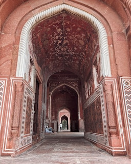 A hallway in a building with intricate designs on the walls