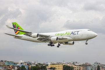 A large jetliner flying through a cloudy sky