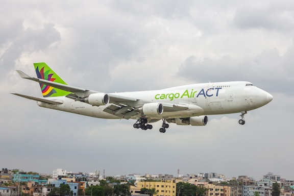 A large jetliner flying through a cloudy sky
