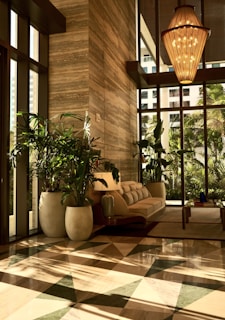 A living room with a checkered floor and large windows