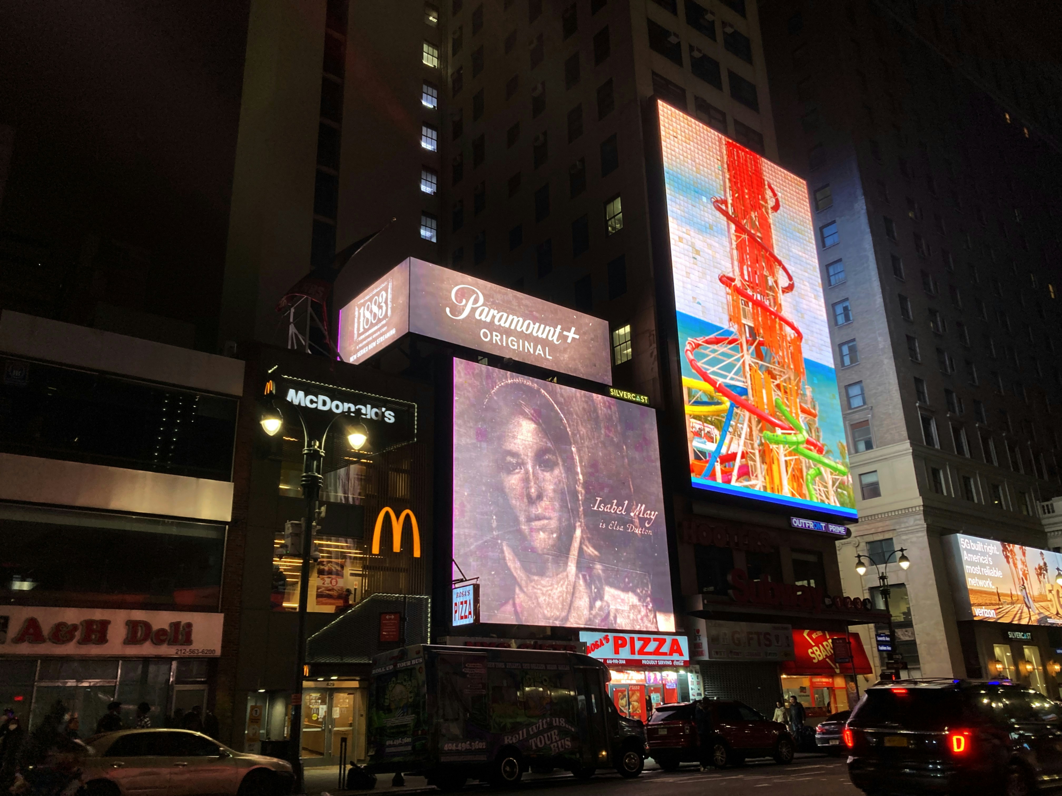 Illuminated LED glow sign board installation at night in commercial area