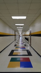 A long hallway with a multicolored pattern on the floor
