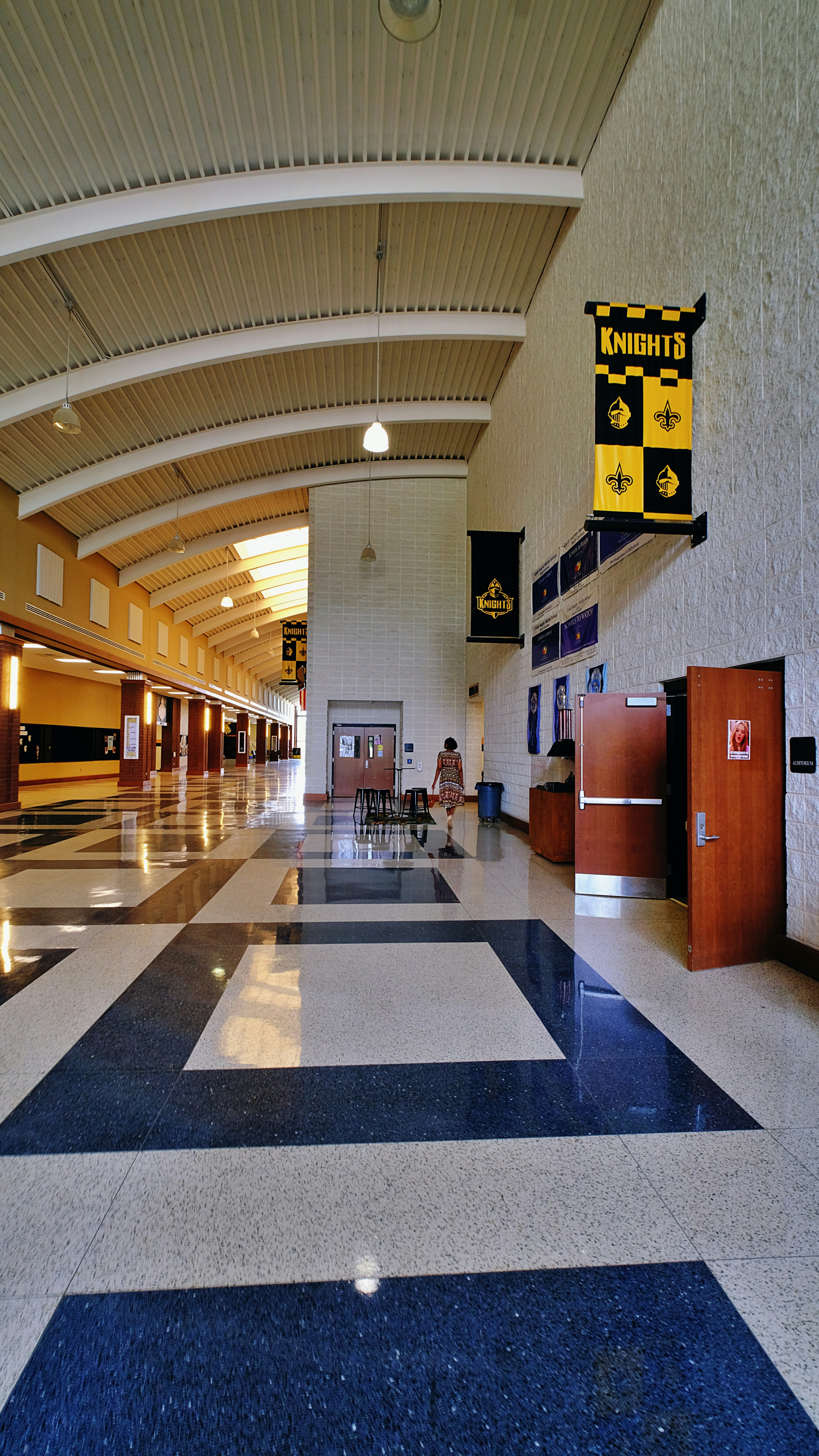 A long hallway with a blue and white checkered floor