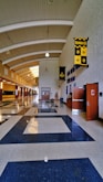 A long hallway with a blue and white checkered floor