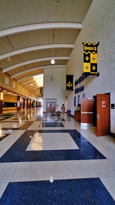A long hallway with a blue and white checkered floor