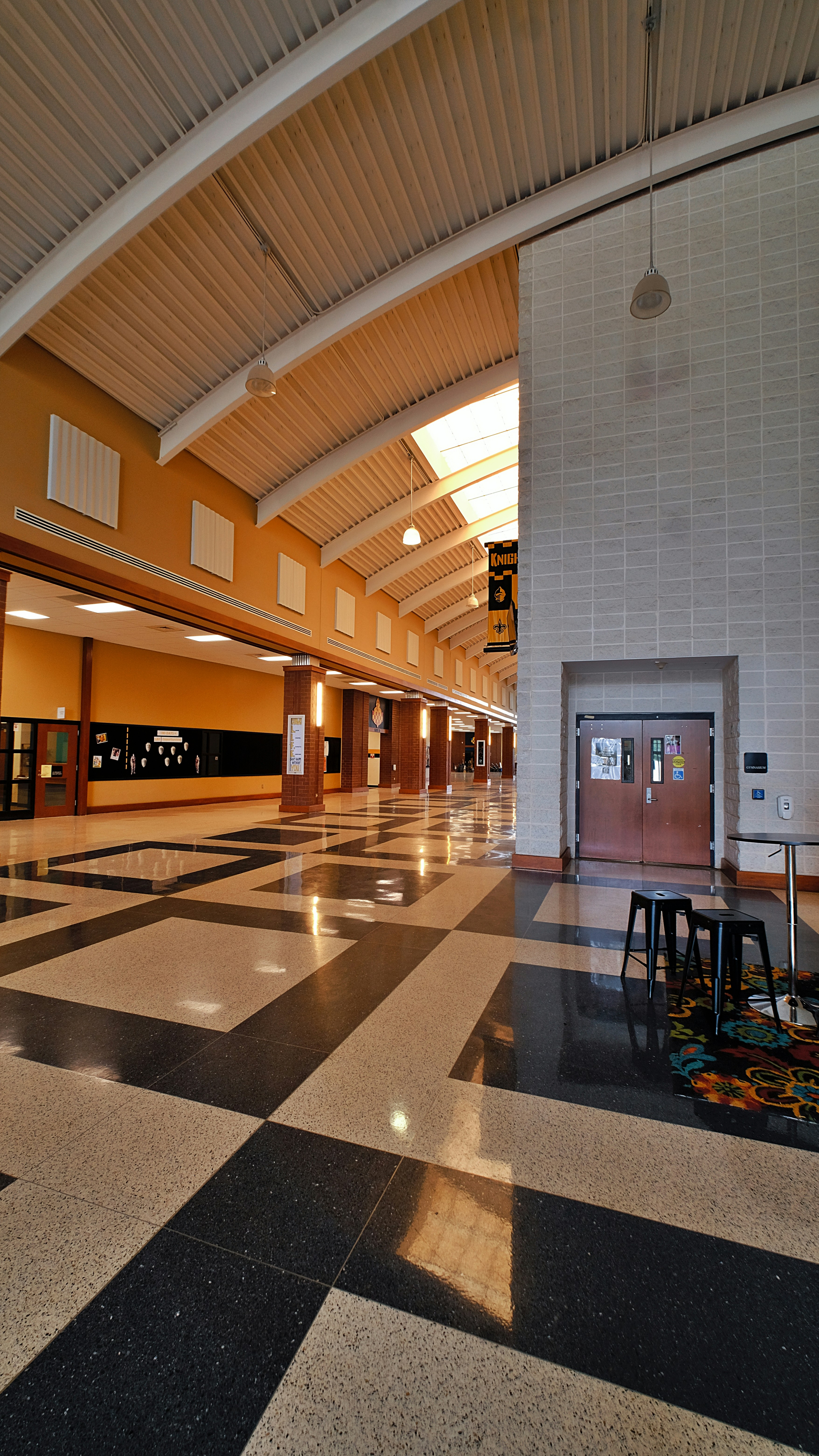A large room with a checkered floor and a door