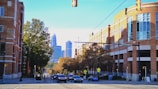 A city street filled with traffic next to tall buildings