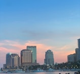 A body of water with a city in the background