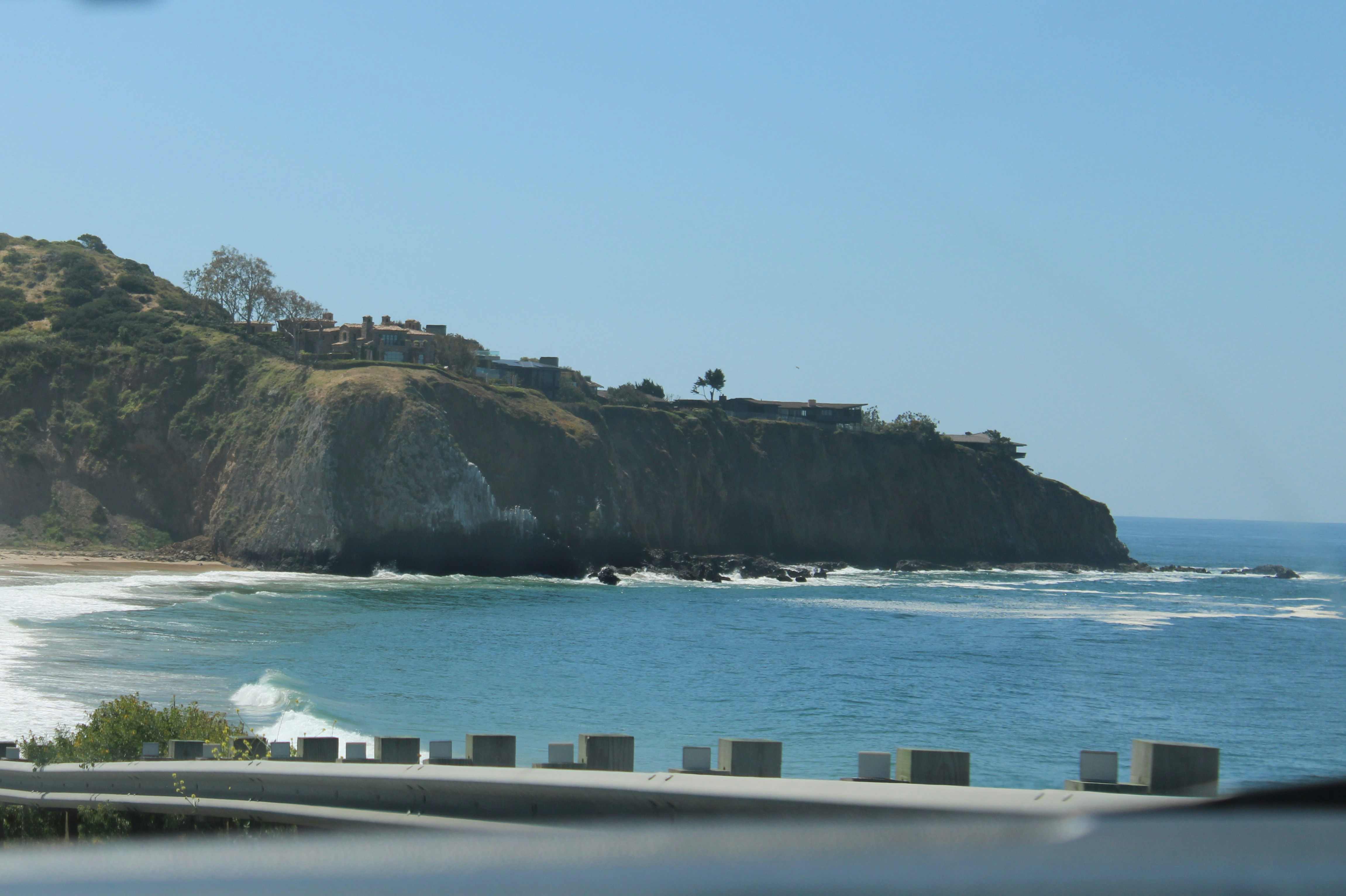 A view of a beach from a car window