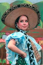 A woman wearing a large hat and dress