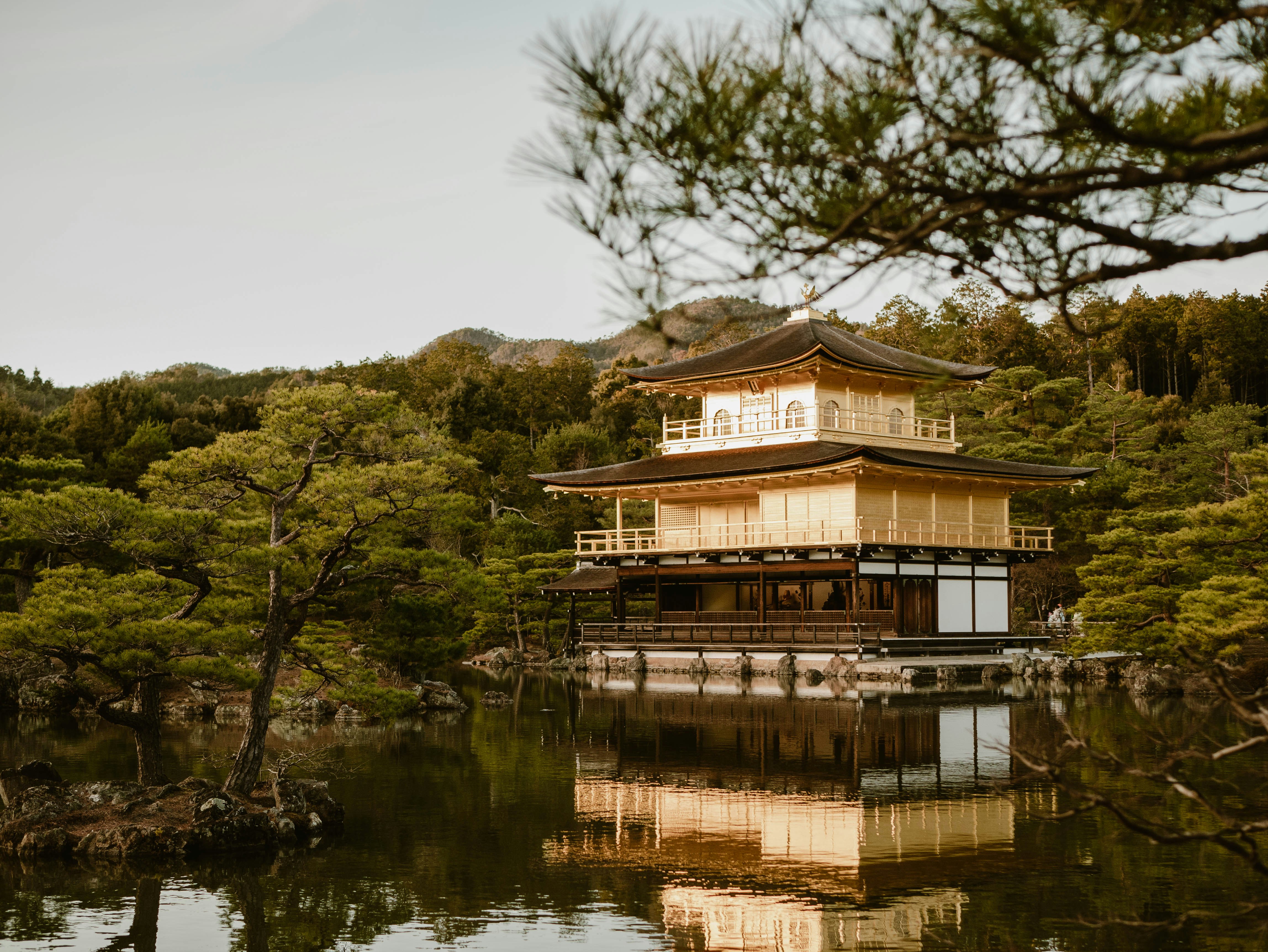 A building sitting on top of a lake surrounded by trees