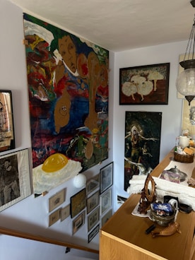 A room with a lot of art on the wall