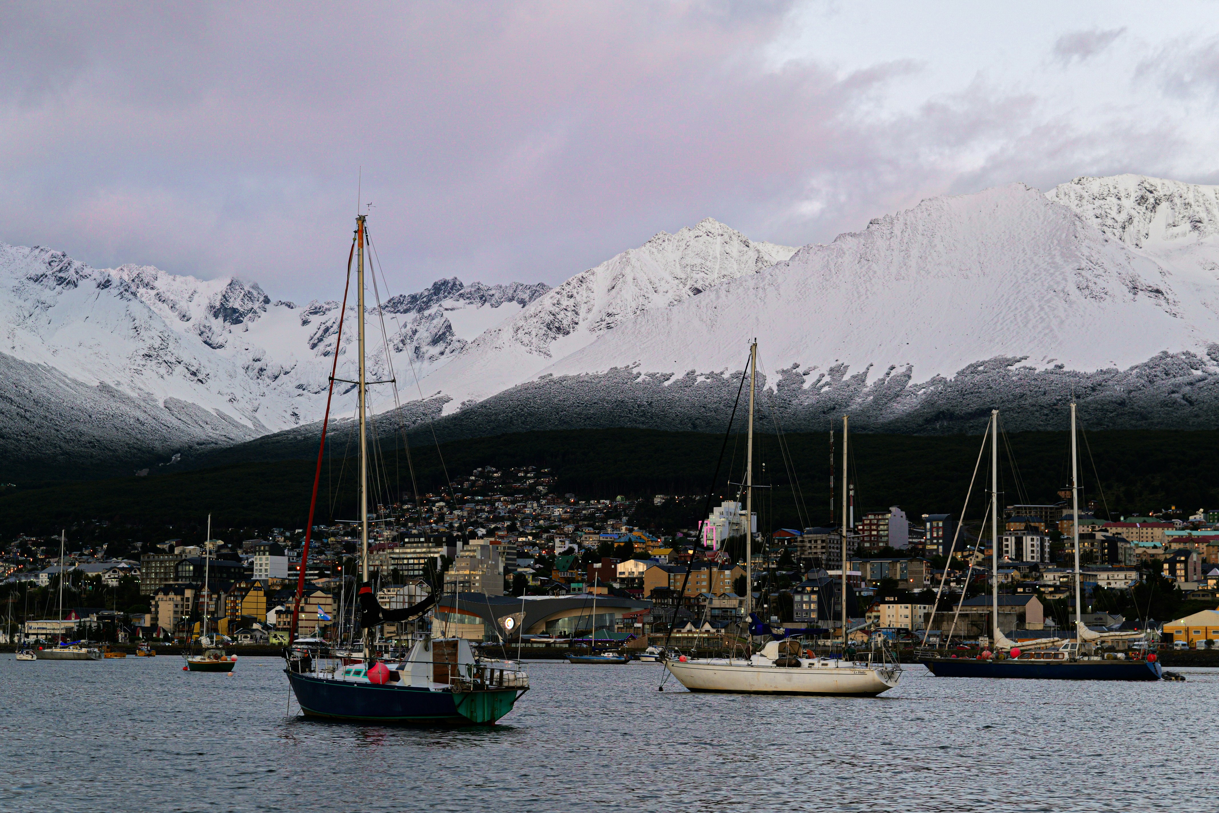 A group of boats floating on top of a body of water