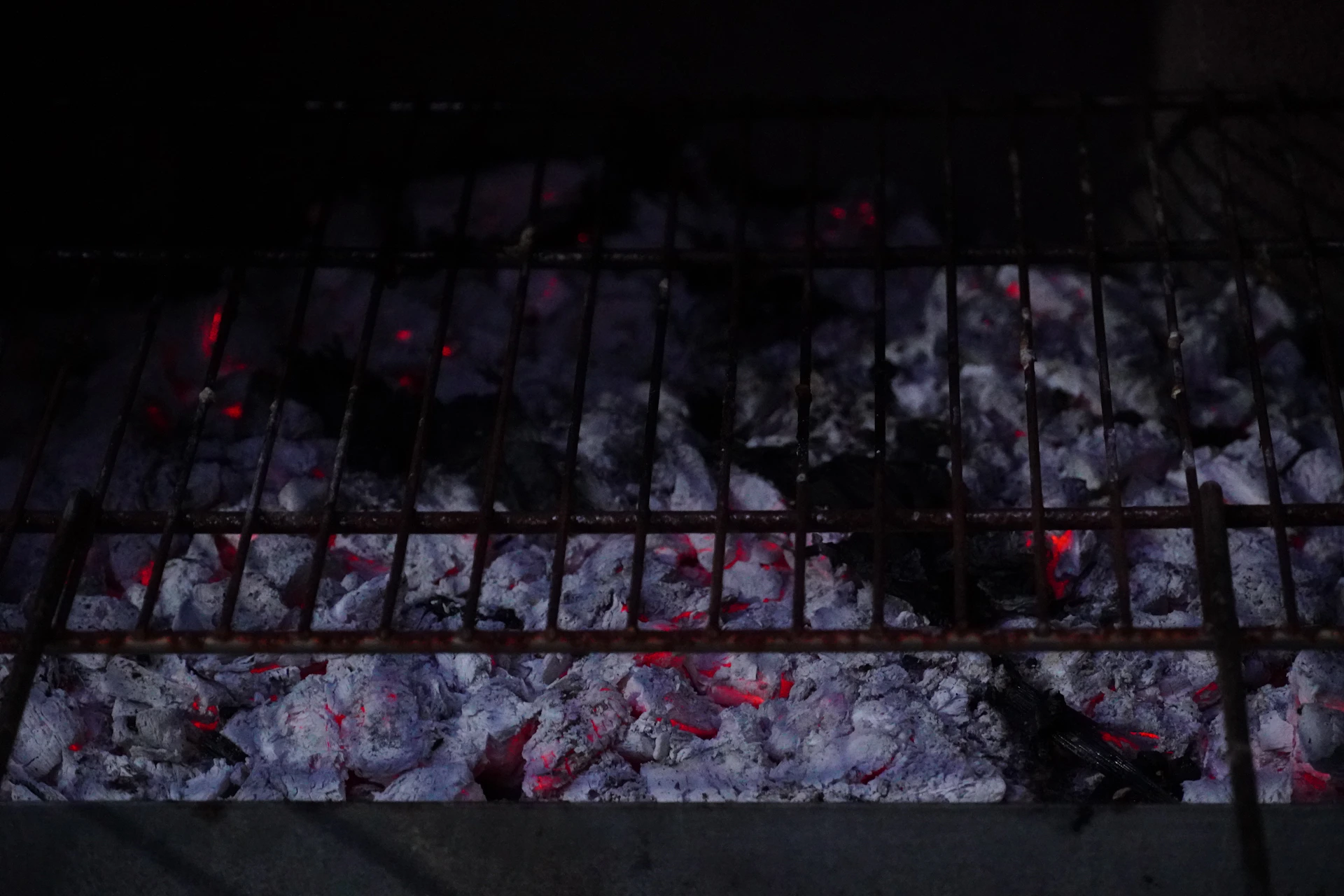 A grill that has some food cooking on it