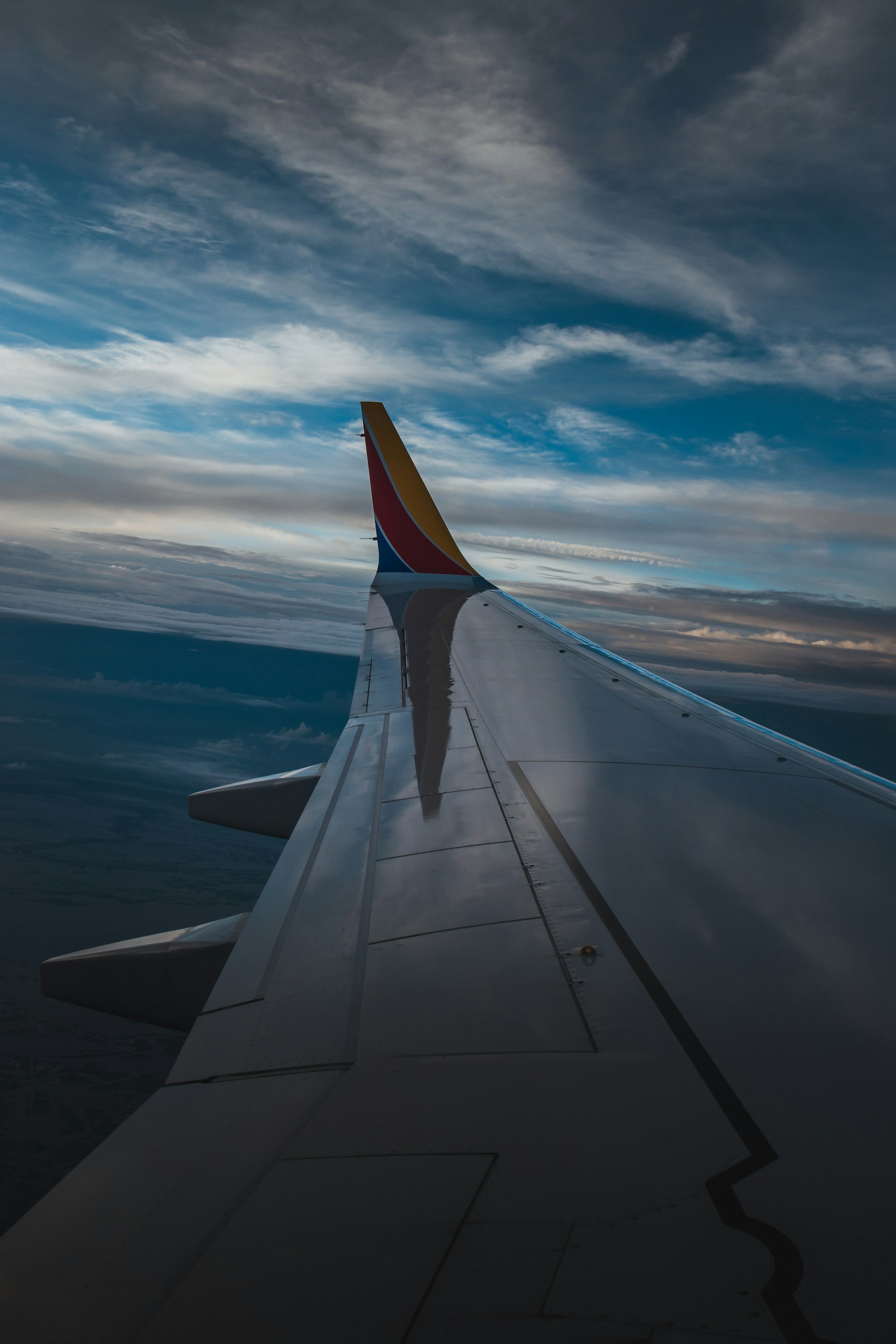 A view of the wing of an airplane in the sky